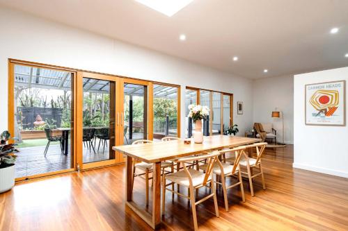 a dining room with a table and chairs at The Greenhouse - Spa & Fire - Pet Friendly in Barwon Heads