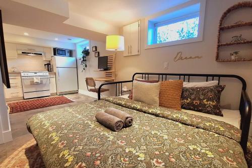 a bedroom with a large bed in a room at Cozy Boho Studio Suite in Calgary