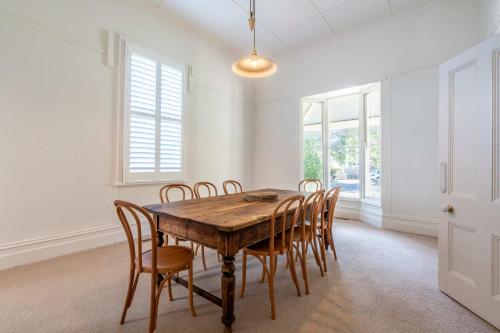 a dining room with a wooden table and chairs at Perfect Point Lonsdale Cottage in Point Lonsdale