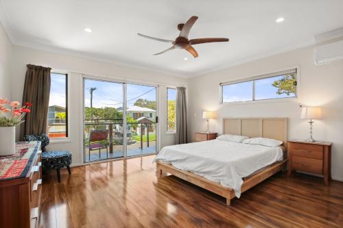a bedroom with a bed and a ceiling fan at Roderick Street 83, Moffat Beach in Caloundra