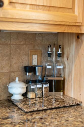 a counter with two bottles of alcohol on a shelf at Manzanita Hill-35 miles to Yosemite, 10 miles to Mariposa with 8 person spa in Mariposa