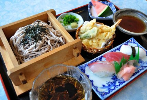 a tray of food with noodles and other foods at Hotel Los Inn Kochi in Kochi