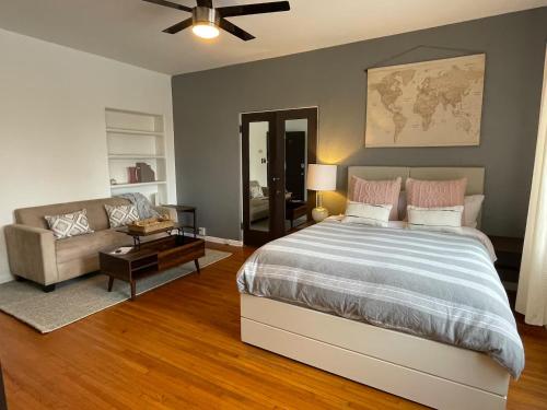 a bedroom with a large bed and a couch at The Riviera in San Pedro