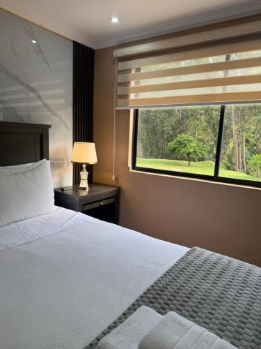 a bedroom with a bed and a large window at House in Miraflores Cuenca in Cuenca