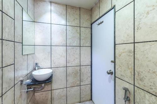 a bathroom with a sink and a shower at Hotel City Inn in Ahmedabad