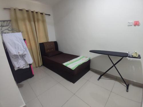 a living room with a chair and a table at k homestay in Jeli