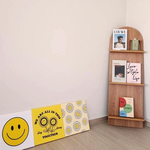 a room with a book shelf and a smiley face box at Donghae Eoul Stay in Donghae