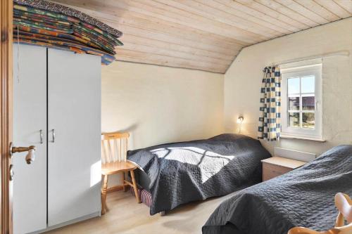 a bedroom with two beds and a window at 377-Harboore-Fourmivej-56 in Harboør
