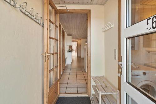 a hallway with a door to a laundry room at 377-Harboore-Fourmivej-56 in Harboør