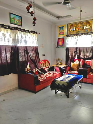 a living room with two couches and a table at Haripriya Guest House 2bhk Solapur in Bāle