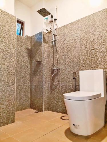 a bathroom with a toilet and a shower at Alzurich Private Resort in Dauin