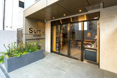 a sun sign on the side of a building at Sumu Ueno East in Tokyo