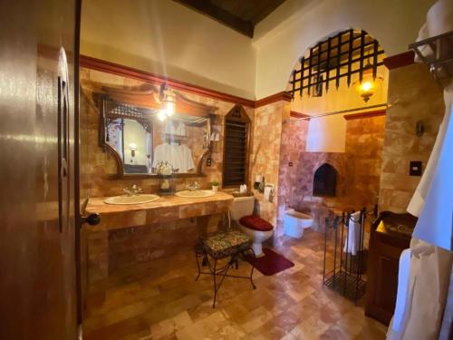 a large bathroom with two sinks and a mirror at Hotel Tropicana Castle Sabang Mindoro in Sabang
