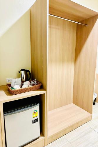 a wooden cabinet with a tv in a room at Lampang Green Garden Resort in Ban Chomphu