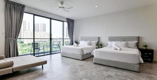 a hotel room with two beds and a balcony at Modern Luxury Villa Hinai by Simple Sanctuary in George Town