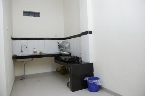 a small kitchen with a sink and a mixer at linns house borobudur syariah malang in Blimbing