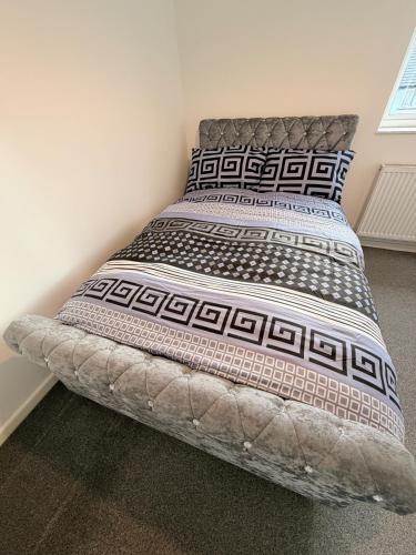 a bedroom with a large bed with two pillows at Precious House 5 in Leicester