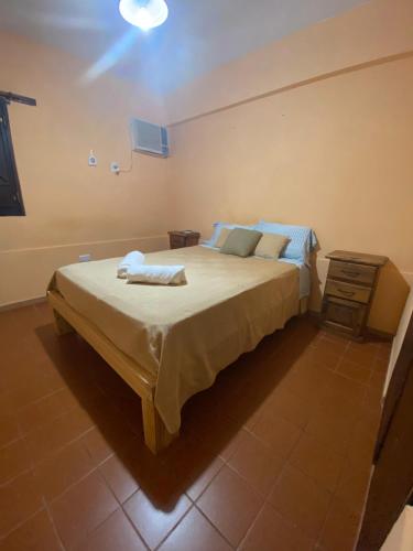 a bedroom with a large bed and a table at Departamento Gallino PB in Corrientes