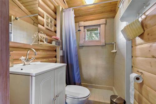a bathroom with a white sink and a toilet at 10006-Rorvig-Hojsandsparken-3 in Rørvig