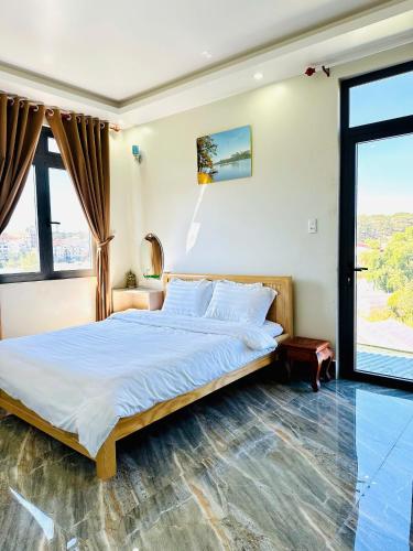 a bedroom with a bed and a large window at Healling home 1 in Da Thien