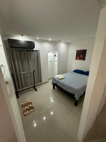 a bedroom with a bed and a shower in it at Departamento Masha in Tizimín