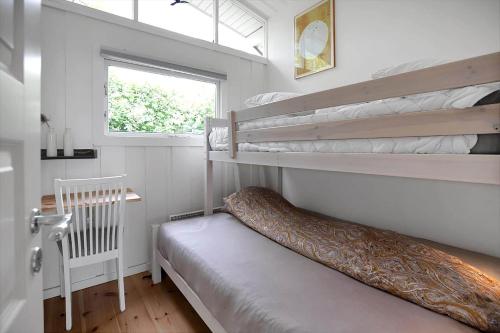 a bedroom with two bunk beds and a window at 14242-Vig-Maglehojvej-6 in Vig