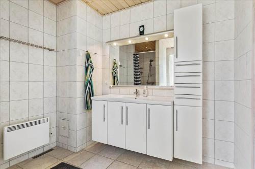 a white bathroom with a sink and a mirror at 13387-Vig-Vej-11-4 in Vig