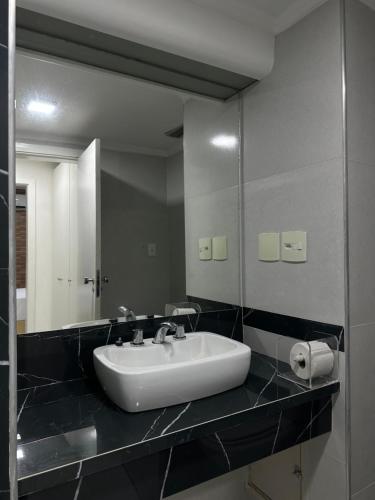 a bathroom with a sink and a large mirror at Caesar Towers Hotel by Asas Tur in Recife