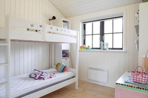 a room with two bunk beds and a window at 10045-1-Rorvig-Birkebakken-3 in Rørvig