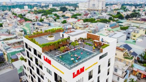 a building with a swimming pool on top of it at LAM Apartment & Hotel Danang - Quiet Living in Modern Comfort in Danang