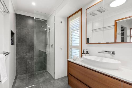 a bathroom with a sink and a shower at Moonraker - Fireplace with Swimming Pool in Broughton Village