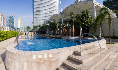 a large swimming pool in a building at Shangri-La Residences The Fort, Manila in Manila
