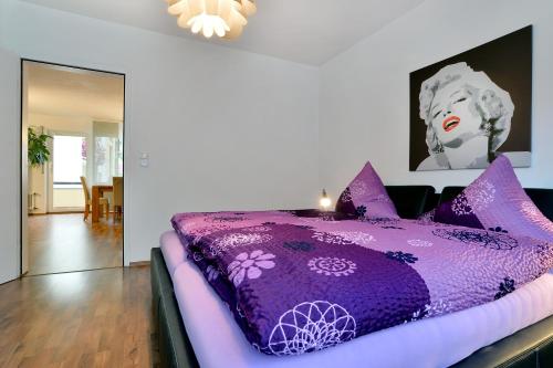 a purple bed with purple pillows in a room at Haus Daniela Superior in Cochem
