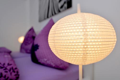 a paper lantern on a table with purple pillows at Haus Daniela Superior in Cochem