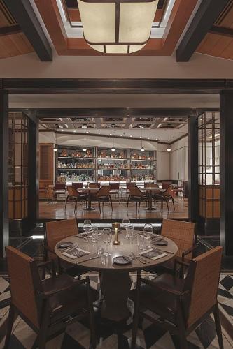 a dining room with a table with wine glasses at Shangri-La Residences The Fort, Manila in Manila