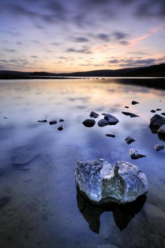 a rock in the middle of a body of water at Beck Hall in Malham