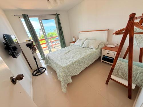 a bedroom with a bed and a window at Nuestros Nietos in Sauce de Portezuelo