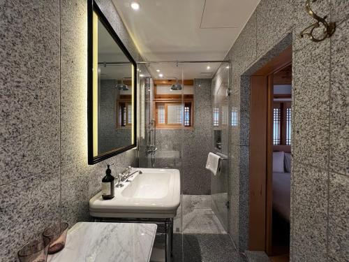 a bathroom with a sink and a mirror at soyeonjae 소연재 in Gyeongju