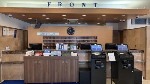 a hotel lobby with a front desk with computers at Toyoko Inn Kumamoto Shin-shigai in Kumamoto