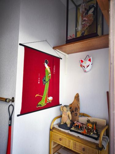 a room with a red flag and a table with a teddy bear at Kyoto151 in Kyoto