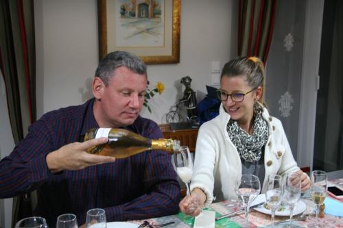 a man and woman sitting at a table drinking wine at Les Suites Champenoises in Reims