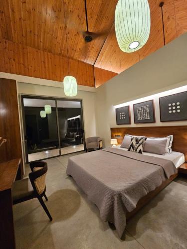 a bedroom with a large bed and wooden ceilings at Hansa Villa in Weligama