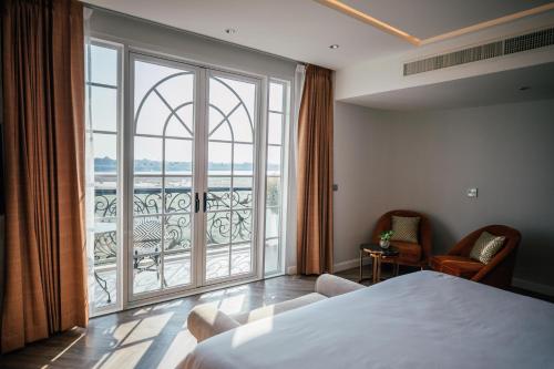 a hotel room with a bed and a large window at La Seine Boutique Hotel in Vientiane