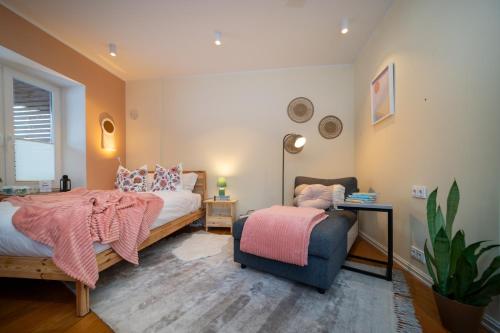 a bedroom with a bed and a chair at Quiet Nature Studio in Lahemaa, Garden, Terrace and pet friendly in Kolga