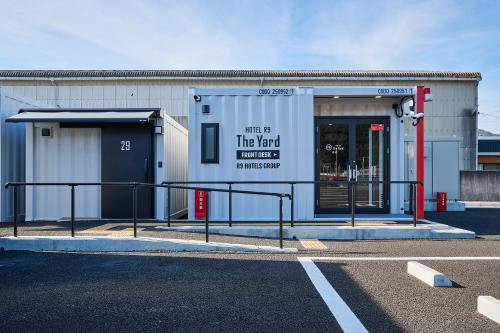 a building with a sign on the side of it at HOTEL R9 The Yard Tamba in Isō