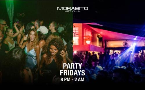 a group of people standing in a crowd at a party at Morabito Art Villa in Canggu