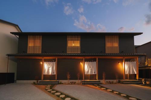 a black building with white drapes on it at 雅音 GAON - Beppu in Beppu