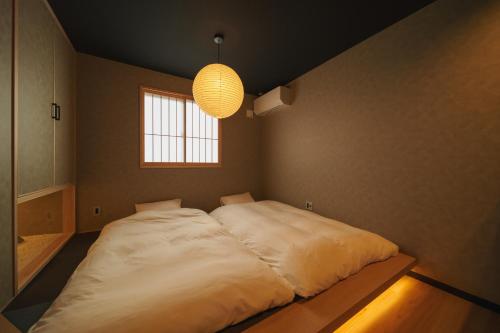 a large bed in a room with a window at 雅音 GAON - Beppu in Beppu