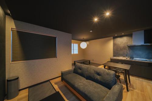 a living room with a couch and a table at 雅音 GAON - Beppu in Beppu