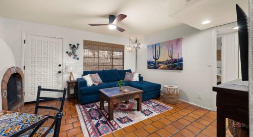 a living room with a blue couch and a table at The Casita Collective in Scottsdale